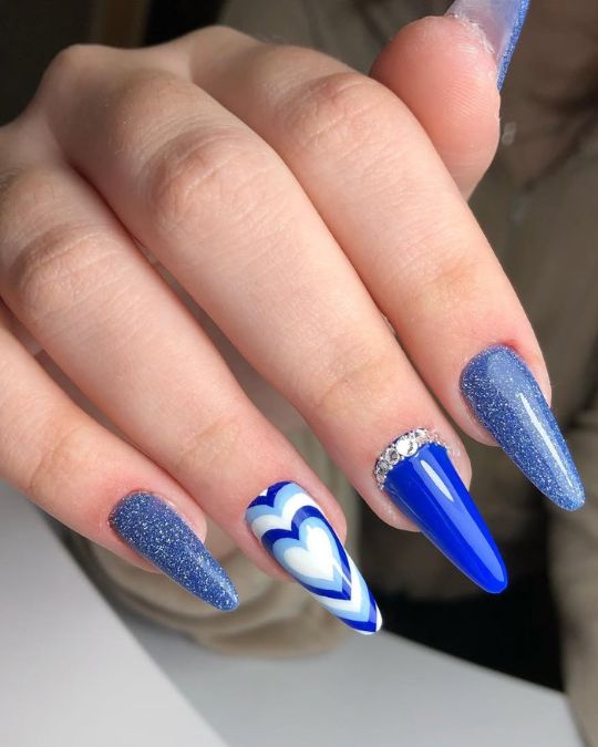 Long stiletto nails featuring various shades of blue