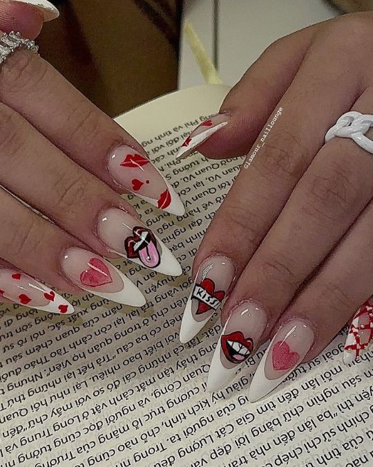 playful stiletto nails feature heart motifs, lip prints, and romantic symbols on a neutral base
