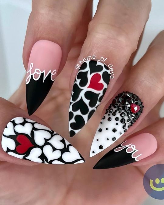 Stiletto nails featuring diverse heart patterns for Valentine's Day Nail