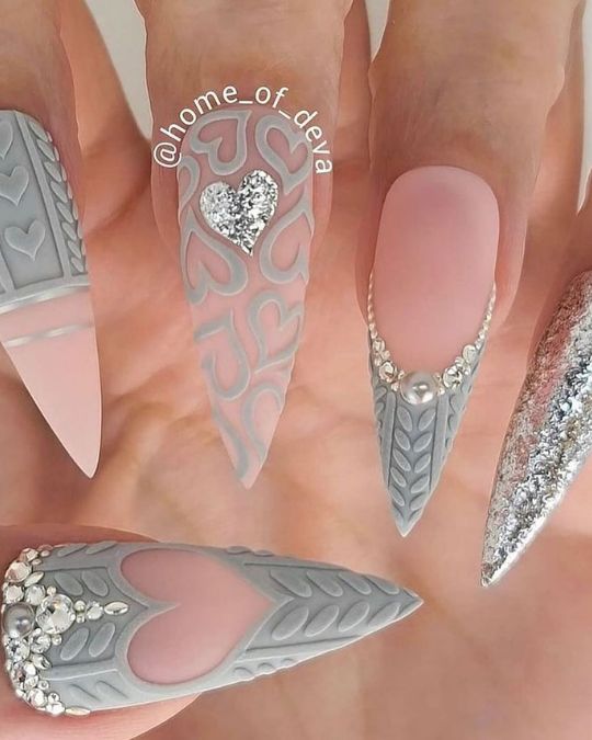 stiletto nails in various shades of gray, from soft dove to shiny silver. Minimalist heart outlines add subtle romance