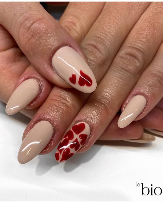 almond-shaped nails Nude Elegance with Red Hearts