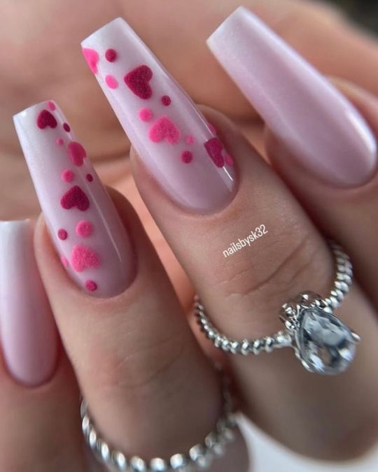 These long coffin nails feature a soft pink base with fuzzy red and pink heart accents