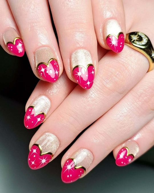 Sparkling gold base with glossy pink heart tips on oval shaped nails