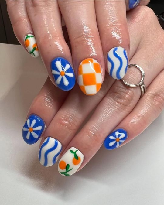 45 Best Summer Nail Ideas to Heat Up Your Style 39 short round nails with bright blue daisies, orange checkers, and cute little citrus fruits