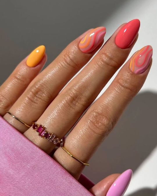 45 Best Summer Nail Ideas to Heat Up Your Style 5 almond-shaped nails with mix of orange, coral, and pink with swirl designs
